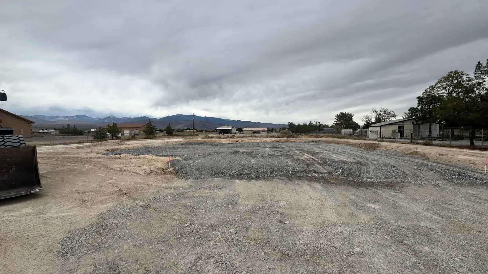Graded and staked building pad at 3681 Percheron Ave in Pahrump, NV, with the Spring Mountains in the background